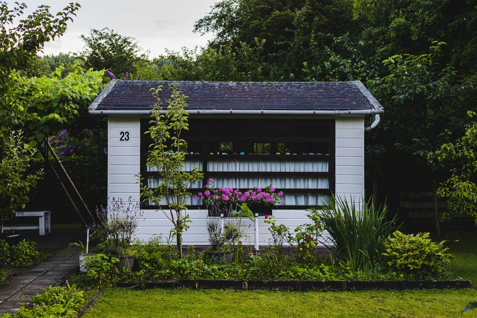 white wooden house near green grass field during daytime